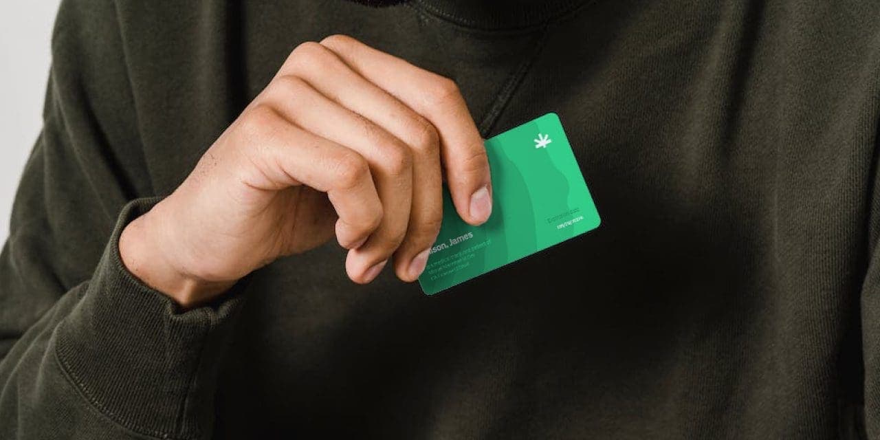 closeup of hand holding a medical marijuana card